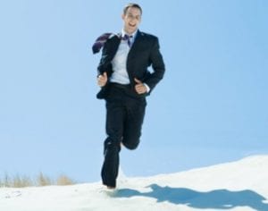 man running on beach in suit